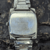 Back view of a Mickey Mouse vintage watch with stainless steel casing and engraved details.