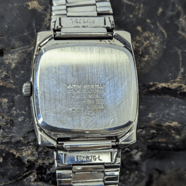Back view of a Mickey Mouse vintage watch with stainless steel casing and engraved details.
