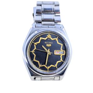 Close-up of Seiko 5 Automatic 17 Jewels Watch with a black and gold dial